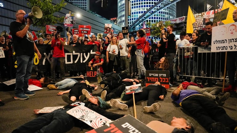 Israeli protesters in Tel Aviv urge their government on Monday...