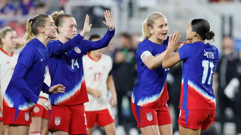 United States' Sophia Smith, right, celebrates her goal against Canada...