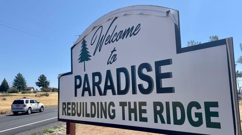 A sign welcomes motorists to Paradise, Calif., on Saturday, Aug....