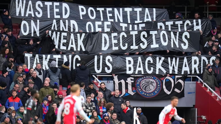 Crystal Palace fans hold a banner on the stands during...
