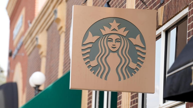 Starbucks sign hangs outside a casino along Main Street Wednesday,...