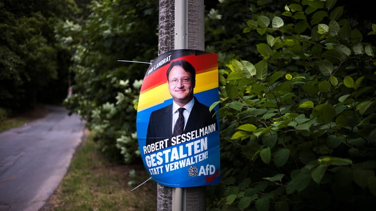 A election campaign poster of far-right AfD candidate Robert Sesselmann...