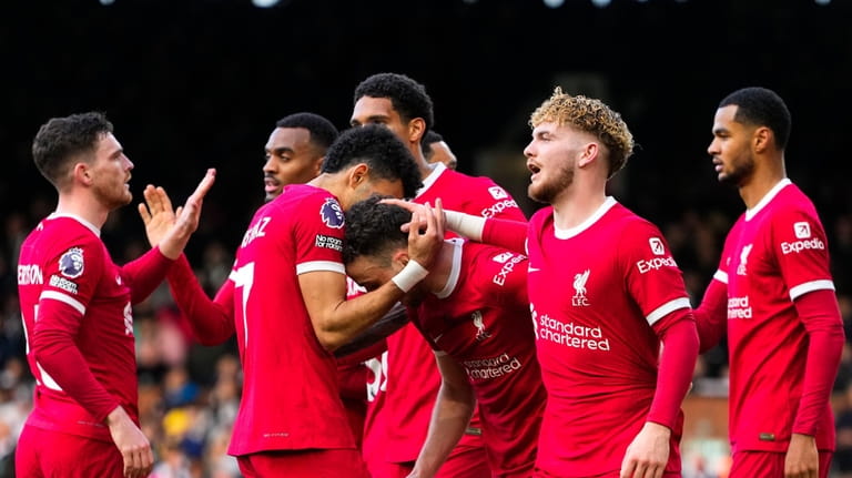 Liverpool's Diogo Jota celebrates with teammates after scoring his side's...