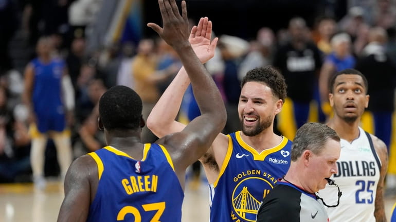Golden State Warriors forward Draymond Green (23) celebrates with guard...