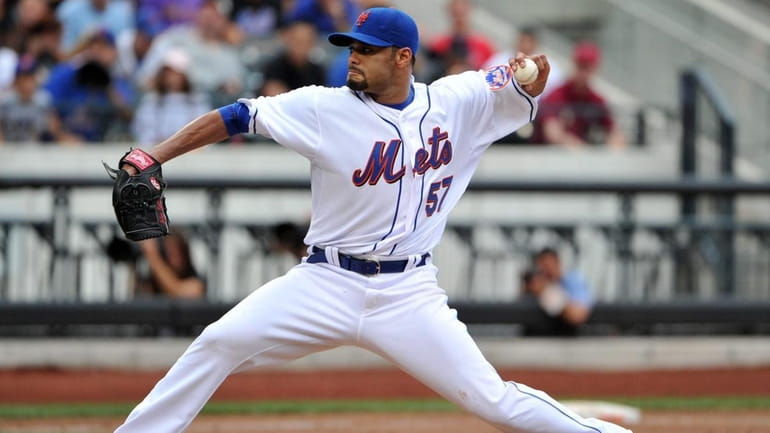 Mets starting pitcher Johan Santana throws in the top of...