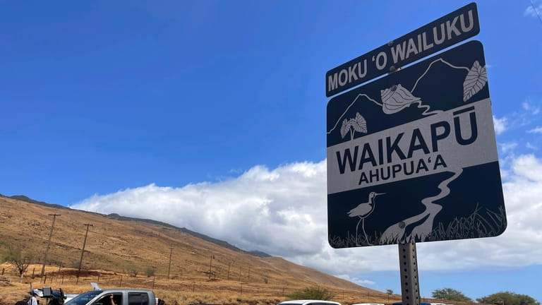 Drivers in West Maui, Hawaii wait in traffic as police...