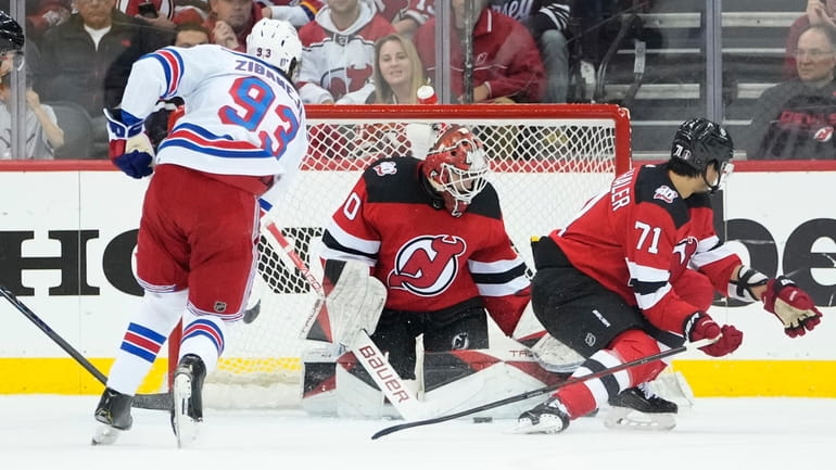 New Jersey Devils goaltender Akira Schmid (40) stops a shot...