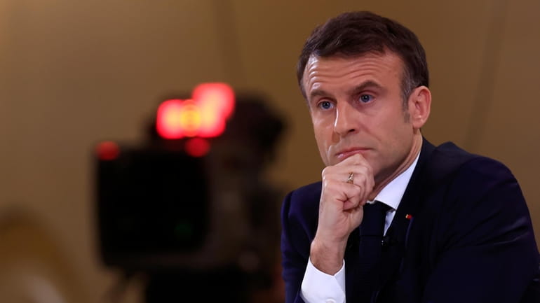 French President Emmanuel Macron listens to a question during his...