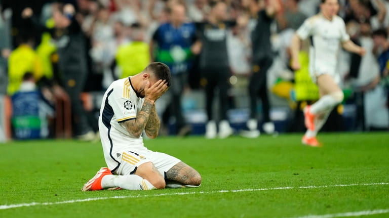 Real Madrid's Joselu reacts after winning the Champions League semifinal...