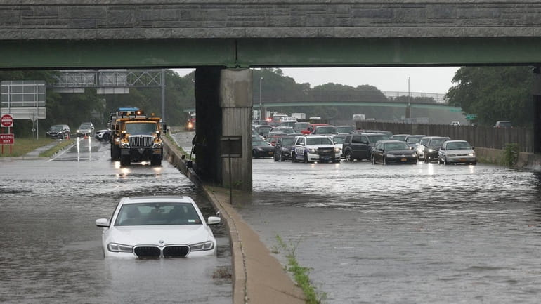 Flooding at Sunrise Highway in East Islip on Sunday morning, where an...