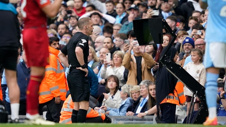 Referee checks VAR for penalty during the English Premier League...