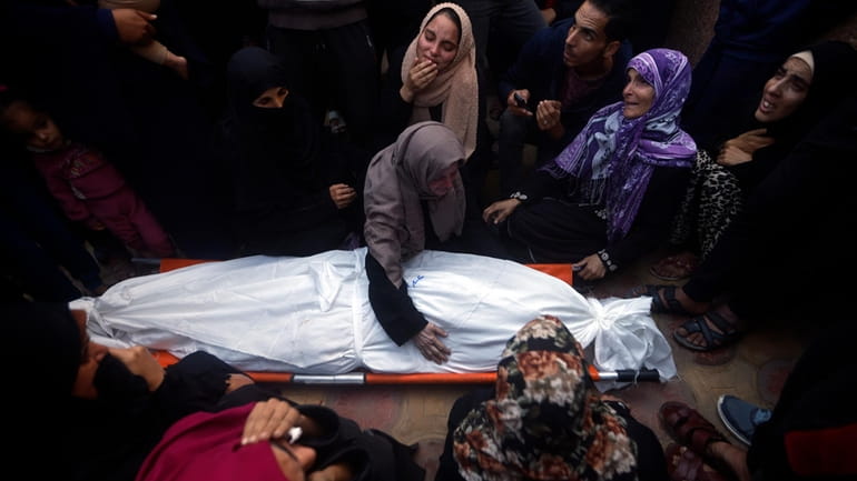 Palestinians mourn relatives killed in an Israeli bombardment of the...