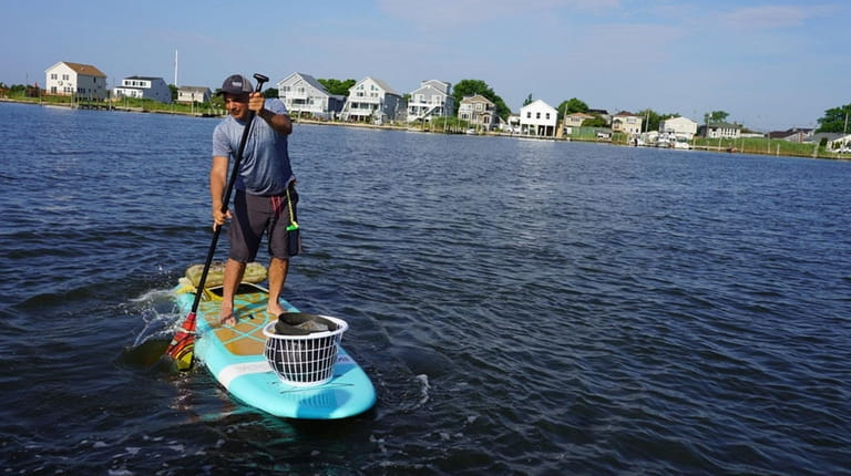 Joe Cerbone of Westhampton is among a group of paddleboarders...