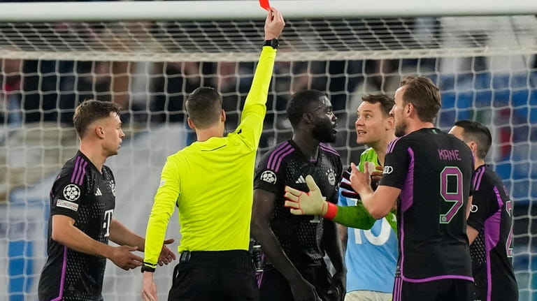 Bayern's Dayot Upamecano receives a red card by referee Francois...