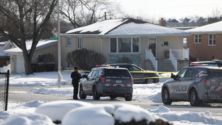 Police work at the scene of a shooting in Tinley...