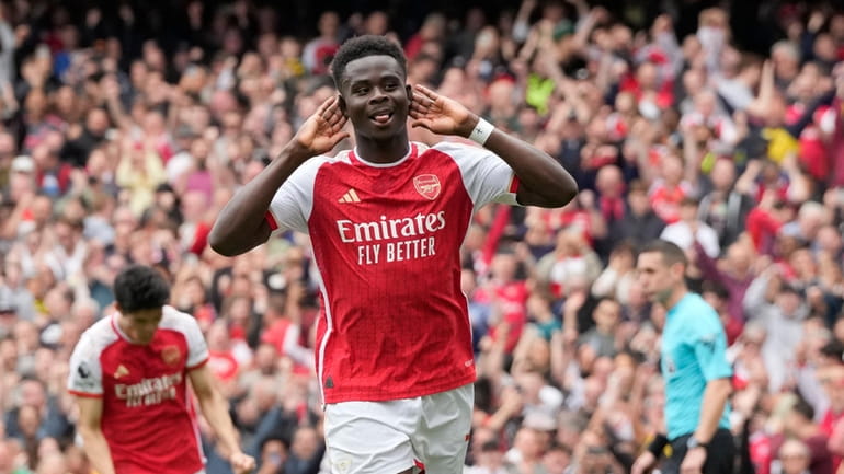 Arsenal's Bukayo Saka celebrates after scoring his side's opening goal...