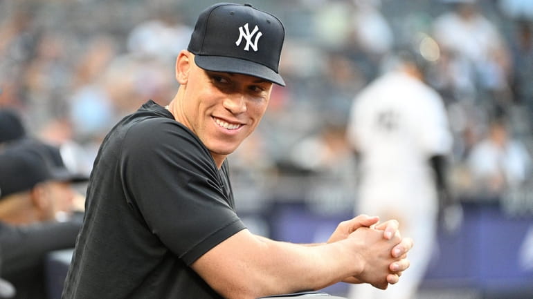 The Yankees' Aaron Judge looks on from the dugout during...