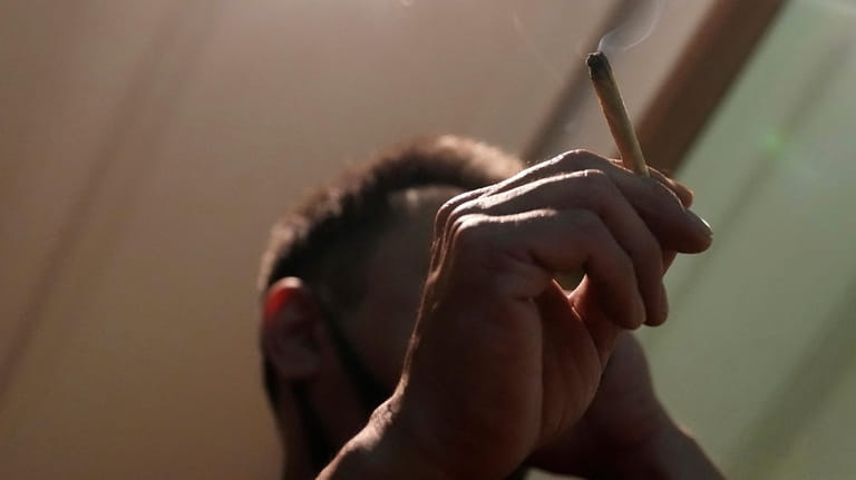 A Japanese tourist smokes cannabis at a Dutch passion shop...