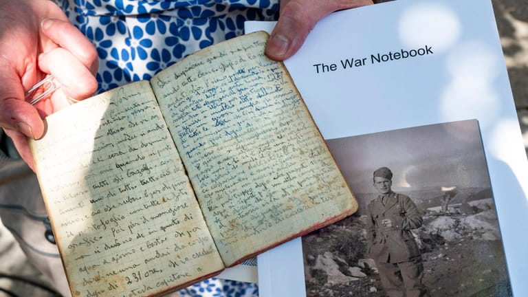 Catherine Blanco holds the war diary of her late father,...