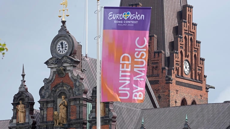 Eurovision flags wave in front of the historic town hall...