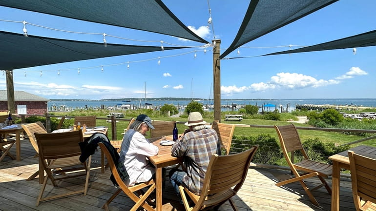 Wall Mural greek outdoor restaurant with Mediterranean sea view