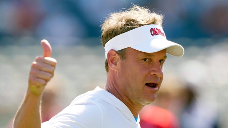 Mississippi coach Lane Kiffin shows his approval at his players...