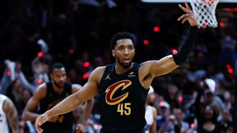 Cleveland Cavaliers guard Donovan Mitchell celebrates after making a three...
