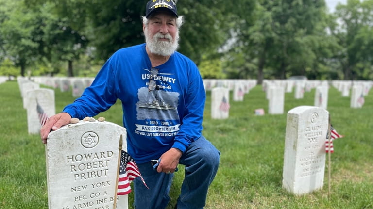 Jeffrey Pribut, a Navy veteran, visits his the grave of...