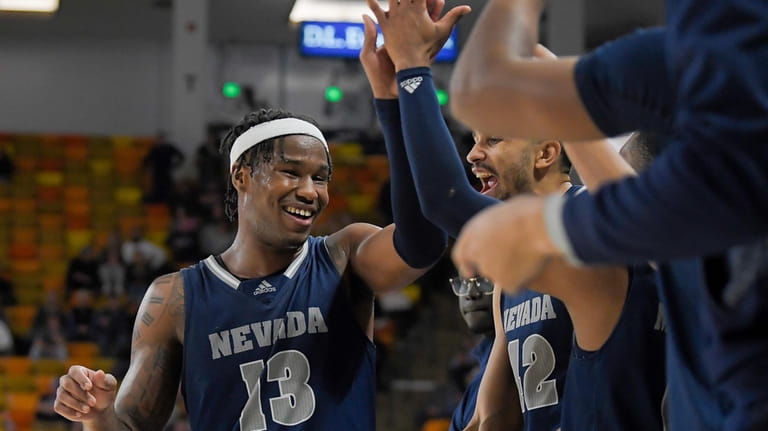 Nevada guard Kenan Blackshear (13) celebrates with teammates during the...