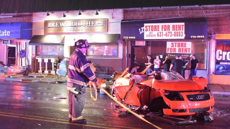 Firefighters at the scene after an alleged DWI crash in...