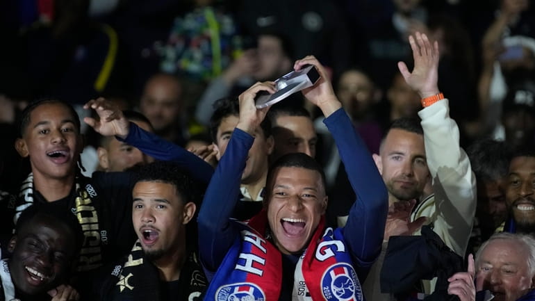 PSG's Kylian Mbappe, centre, celebrates with his teammates PSG's French...