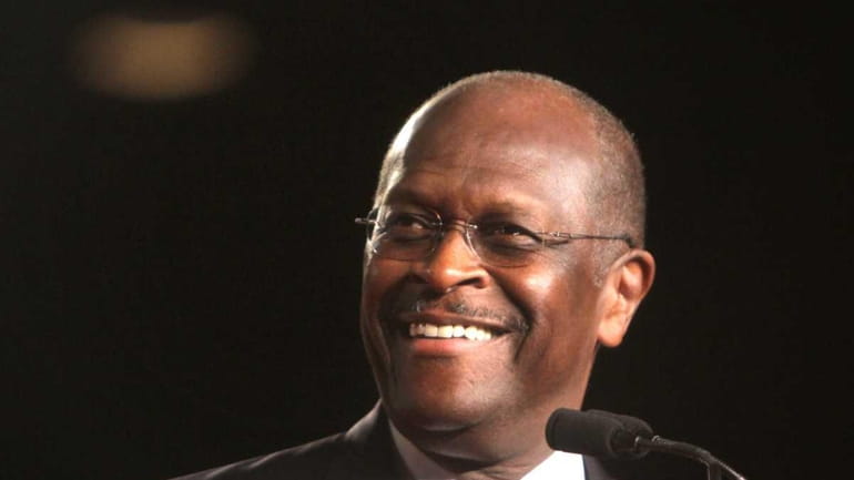 Republican presidential candidate Herman Cain arrives onstage to address the...
