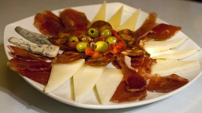 The meat and cheese platter with assorted cheeses, meats, olives...