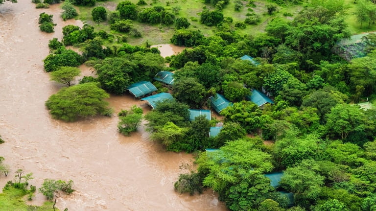 Aerial view of flooded Maasai Mara National Reserve, that left...
