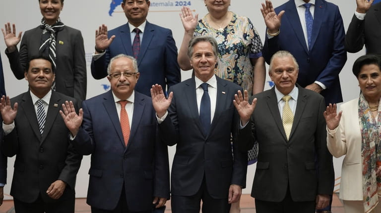 Guatemalan Foreign Minister Carlos Ramiro Martinez Alvarado, front row, second...