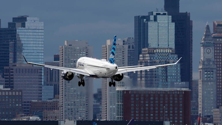 A plane lands at Logan International Airport, Thursday, Jan. 26,...