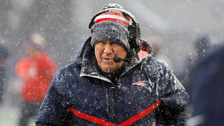 New England Patriots head coach Bill Belichick looks on in...