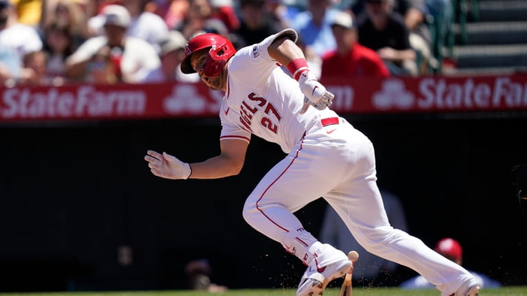 Los Angeles Angels designated hitter Mike Trout runs after grounding...