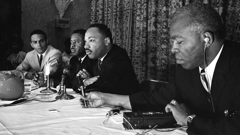 The Rev. Martin Luther King, center, speaks with the media...