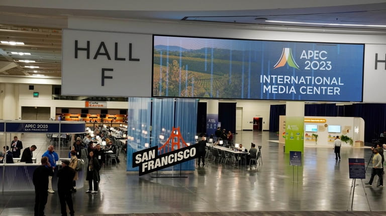 Signs welcome visitors to the APEC Summit, Monday, Nov. 13,...