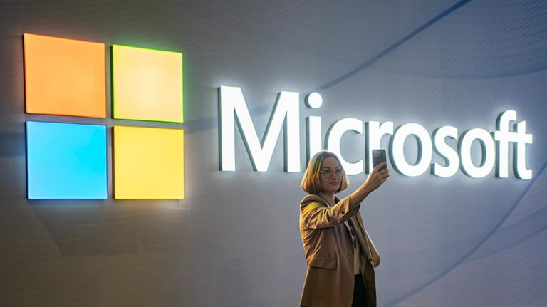 A visitor takes a photo at the Microsoft stand at...