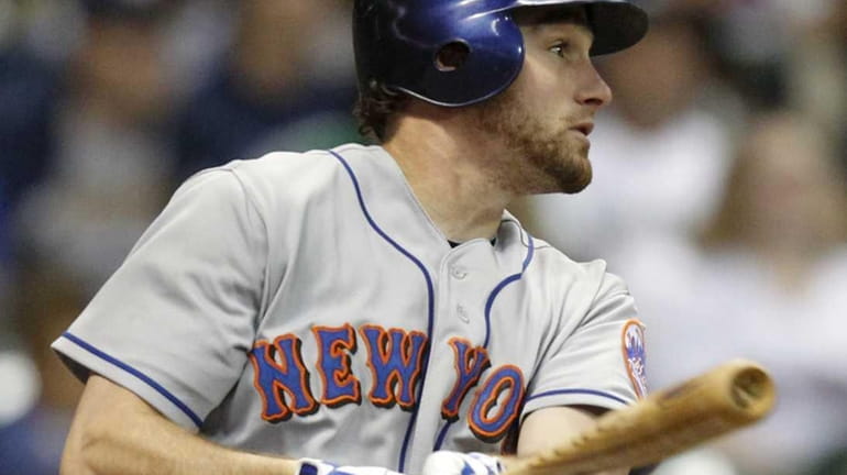 New York Mets' Daniel Murphy watches his run-scoring double against...
