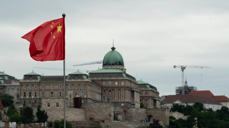 A Chinese national flag with the Buda Castle in the...