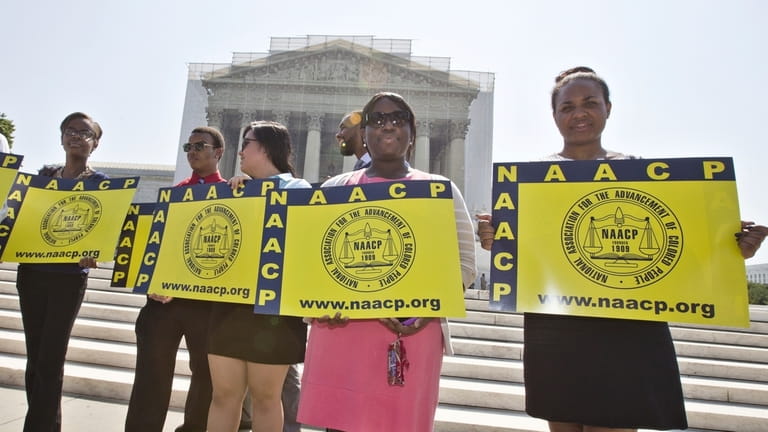 Representatives from the NAACP Legal Defense Fund stand outside the...