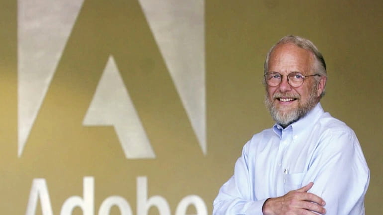 Adobe co-founder John Warnock smiles in the lobby at Adobe...