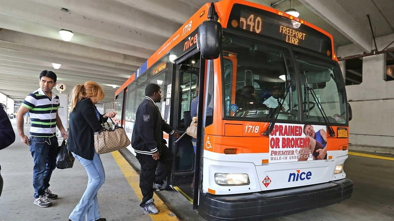 A NICE bus picks up passengers in Mineola on Oct....
