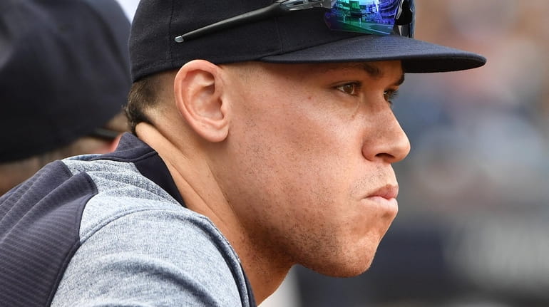 The Yankees' Aaron Judge looks on from the dugout at Yankee...