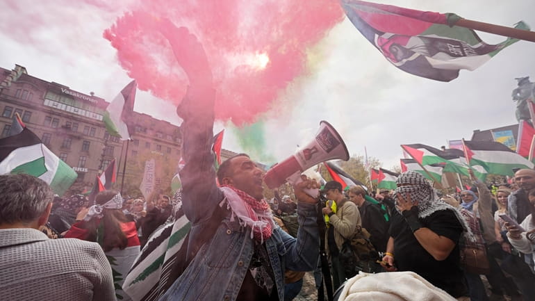 A protester shouts into a megaphone during a Pro-Palestinian demonstration...