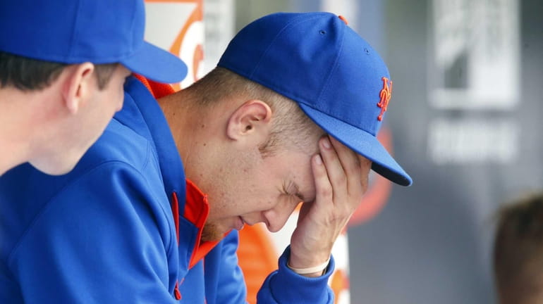 Zack Wheeler sits in the dugout after the fifth inning...