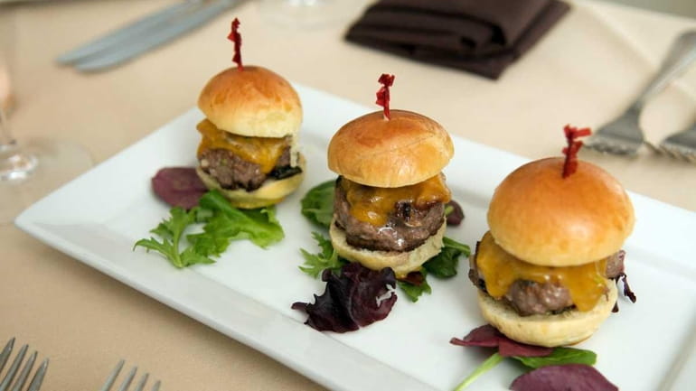 A platter of grilled sirloin sliders with aged Cheddar, smoked...